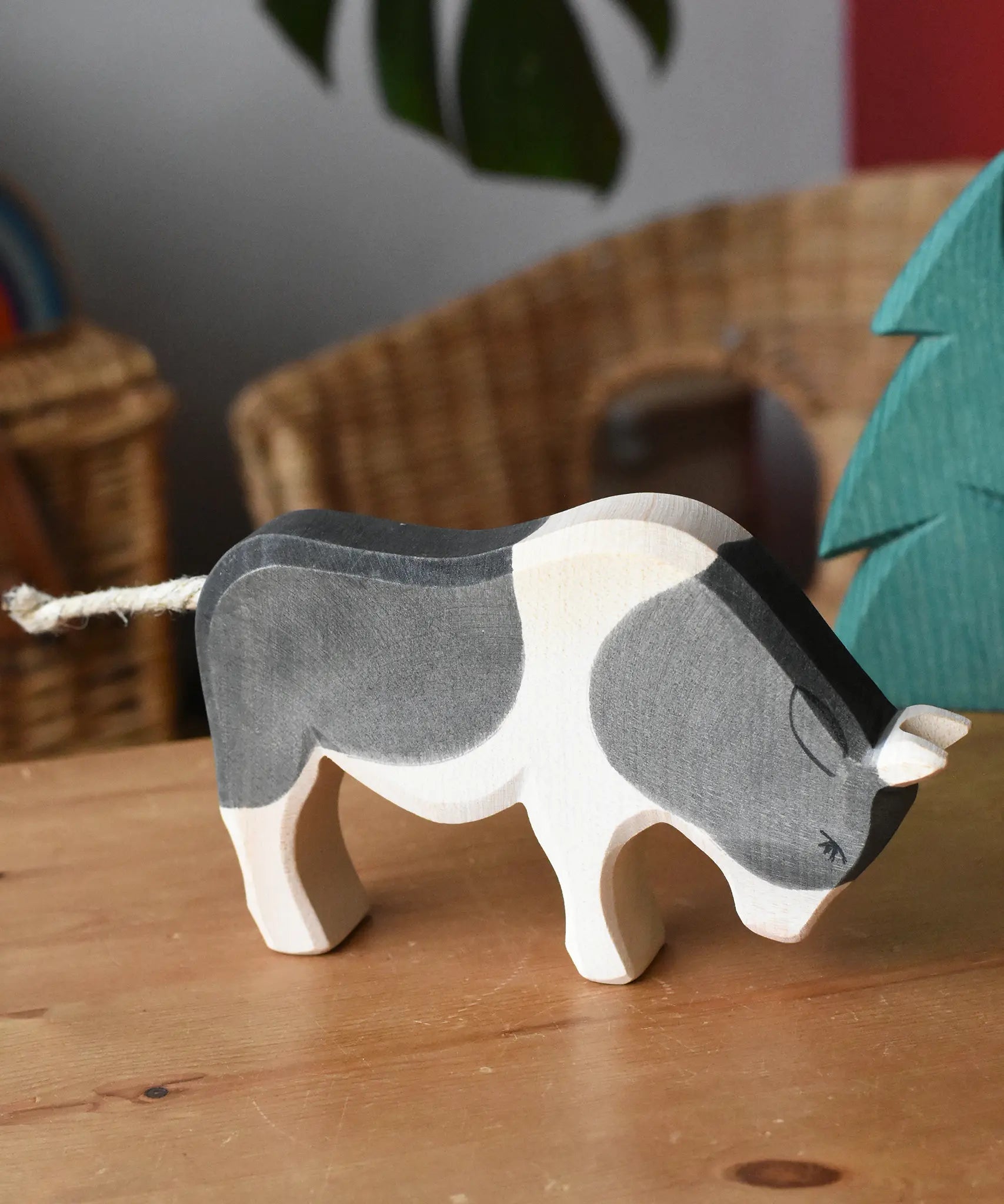 Ostheimer black and white ox wooden toy figure placed on a wooden surface in the Babipur playroom.