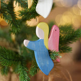 Ostheimer blue angel wooden handmade decoration placed on a Christmas tree branch. 