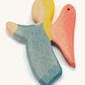 A blue wooden angel figure on a cream background.