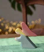 Ostheimer blue kneeling angel wooden toy figure placed on a green cotton play cloth.