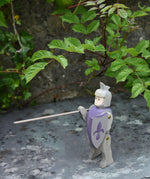 Ostheimer blue riding wooden knight placed on a slate surface outdoors.