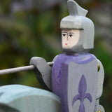 Close up of the Ostheimer blue riding wooden knight sitting on the grey horse.