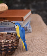 An Ostheimer blue parrot perching on the side of a Kraul basket.
