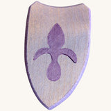 A blue wooden shield with a emblem for a knight on a cream background
