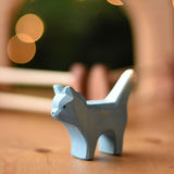 An Ostheimer Bremer cat wooden toy figure placed on a wooden surface.  Ostheimer's range of hand crafted, heirloom quality wooden toys are available to buy at Babipur. 