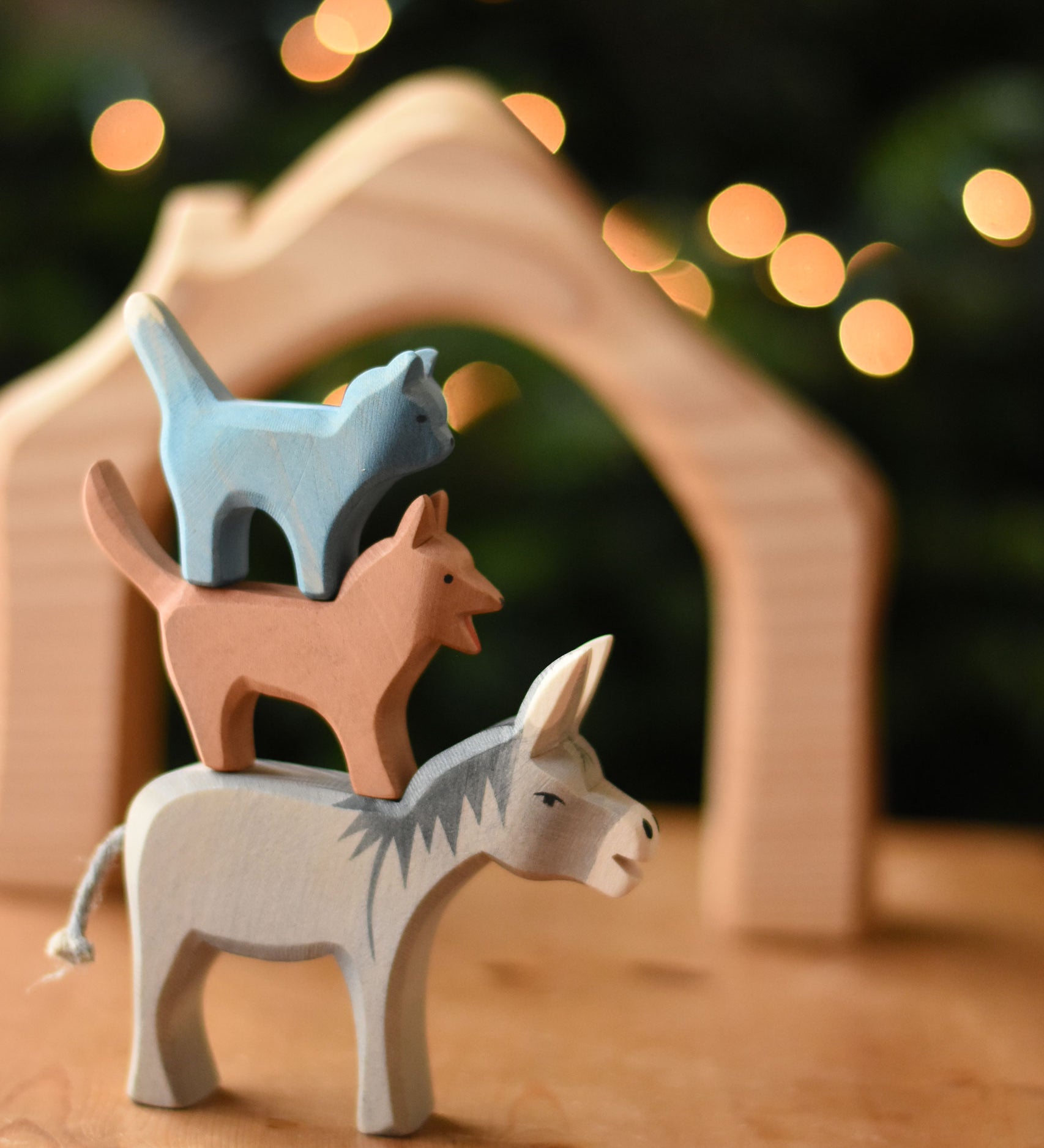 Ostheimer donkey, dog and cat Bremer wooden toy figures stacked on top of each other.  Ostheimer's range of hand crafted, heirloom quality wooden toys are available to buy at Babipur. 