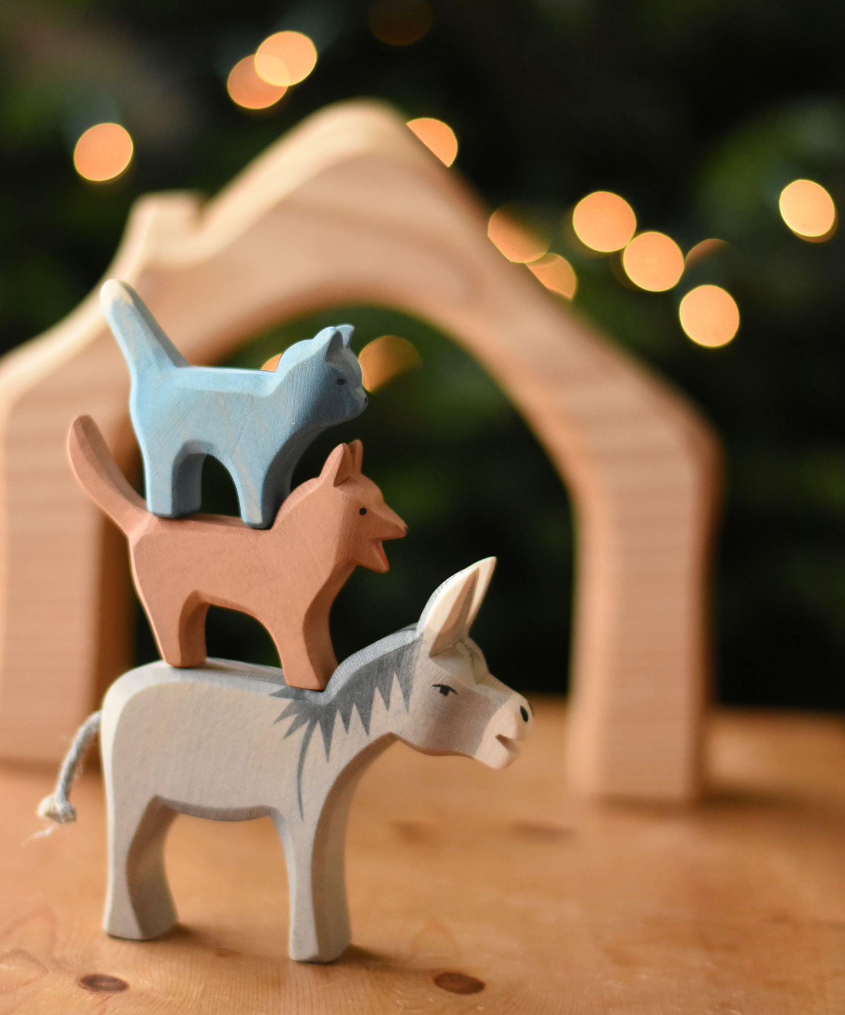 Ostheimer donkey, dog and cat Bremer wooden toy figures stacked on top of each other.  Ostheimer's range of hand crafted, heirloom quality wooden toys are available to buy at Babipur. 