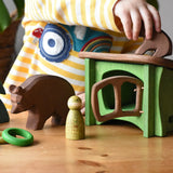 Small world play scene with Ostheimer brown bears  wooden toy figures small spruce tree and green hutch and Grapat peg dolls and rings. 