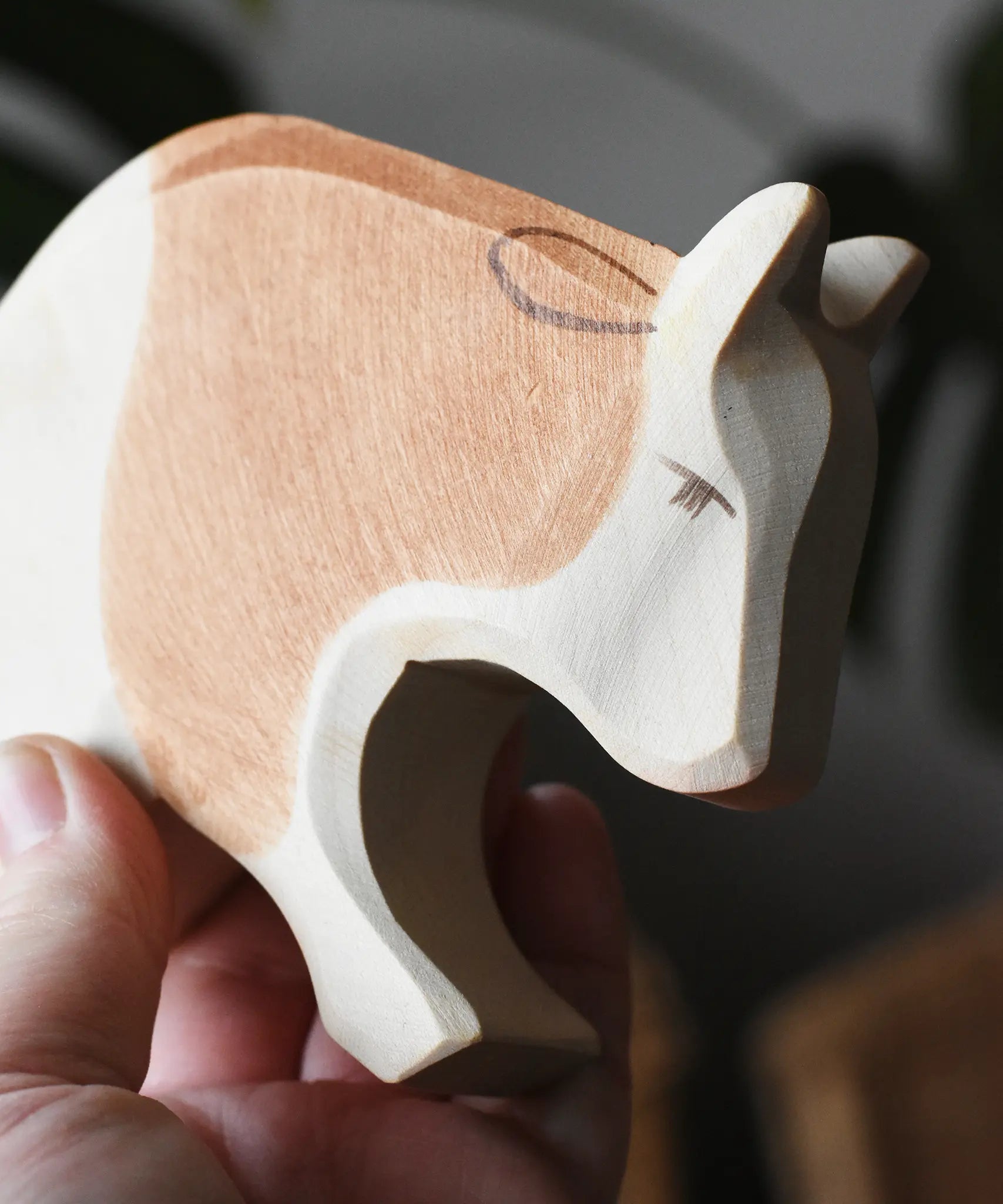 Ostheimer brown and white ox wooden toy figure, close up of the face.