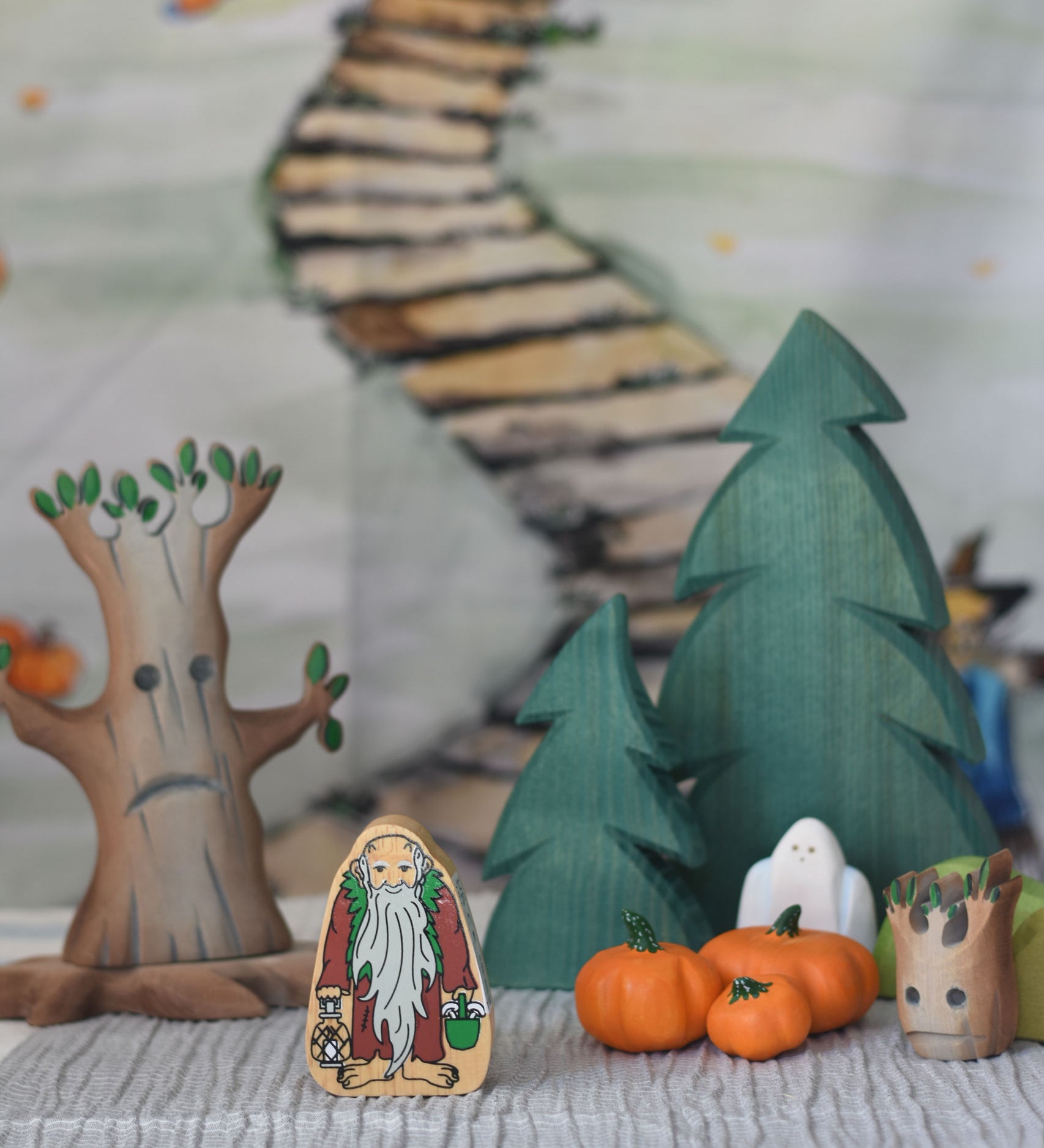 A selection of wooden toys from various brands set up in a small world play scene set up with the Lanka Kade Hermit figure at the front.
We stock a wide range of wooden toys from various brands such as Lanka Kade, Ostheimer, Bumbu and more here at Babipur. 