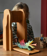 Child placing a dragon on the Ostheimer castle drawbridge.