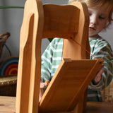 Child playing with the Ostheimer castle drawbridge, opening it up.