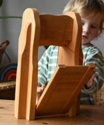 Child playing with the Ostheimer castle drawbridge, opening it up.