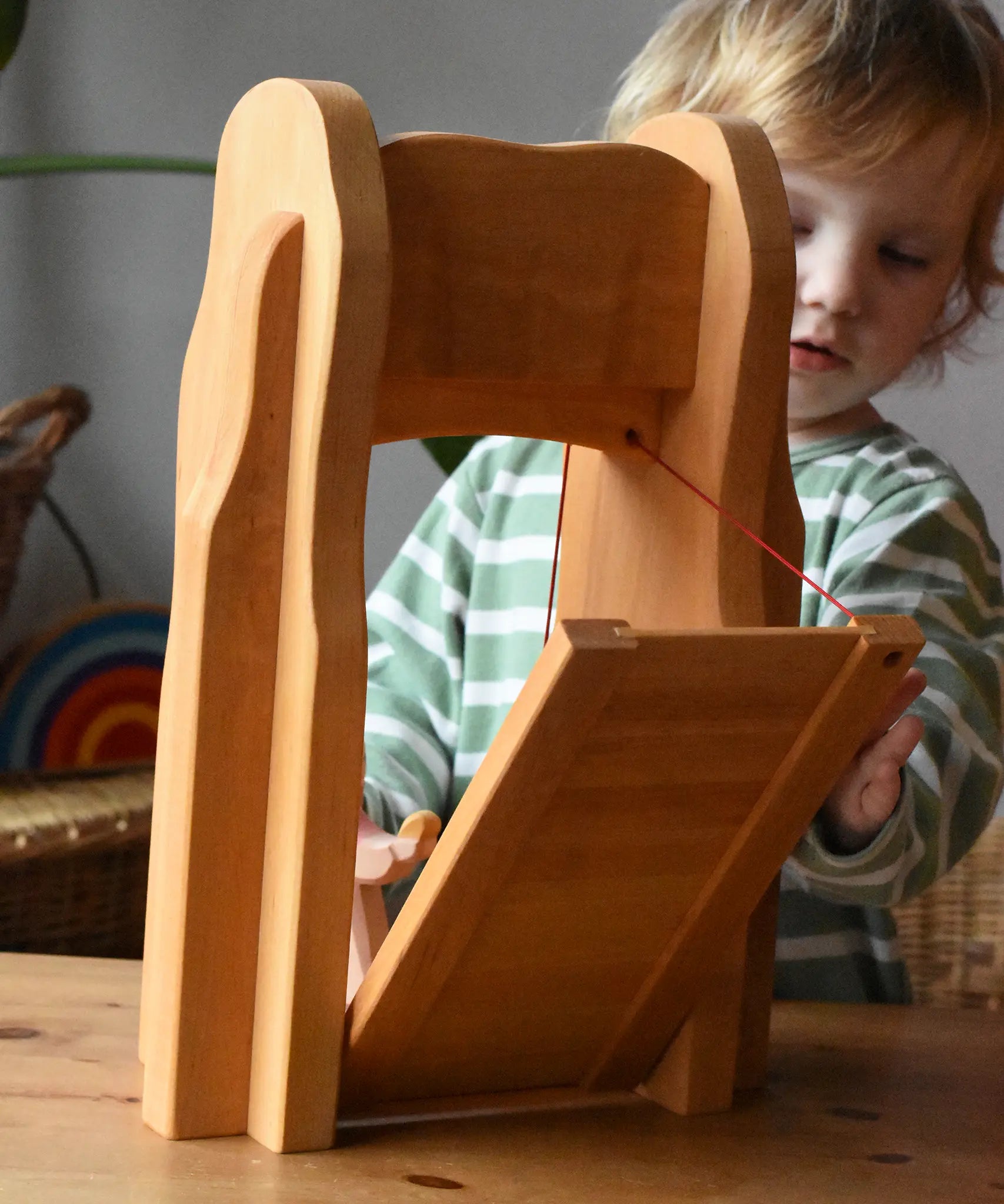 Child playing with the Ostheimer castle drawbridge, opening it up.