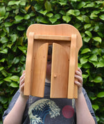 Ostheimer castle gate in a child's hands with locking bar taken off and child peering through.