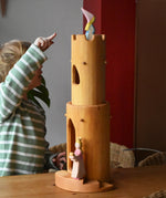 Child pointing at the Ostheimer medieval princess placed in the top of the castle round tower with stairs.
