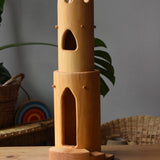 Ostheimer castle round tower with stairs wooden toy building placed on a wooden surface.