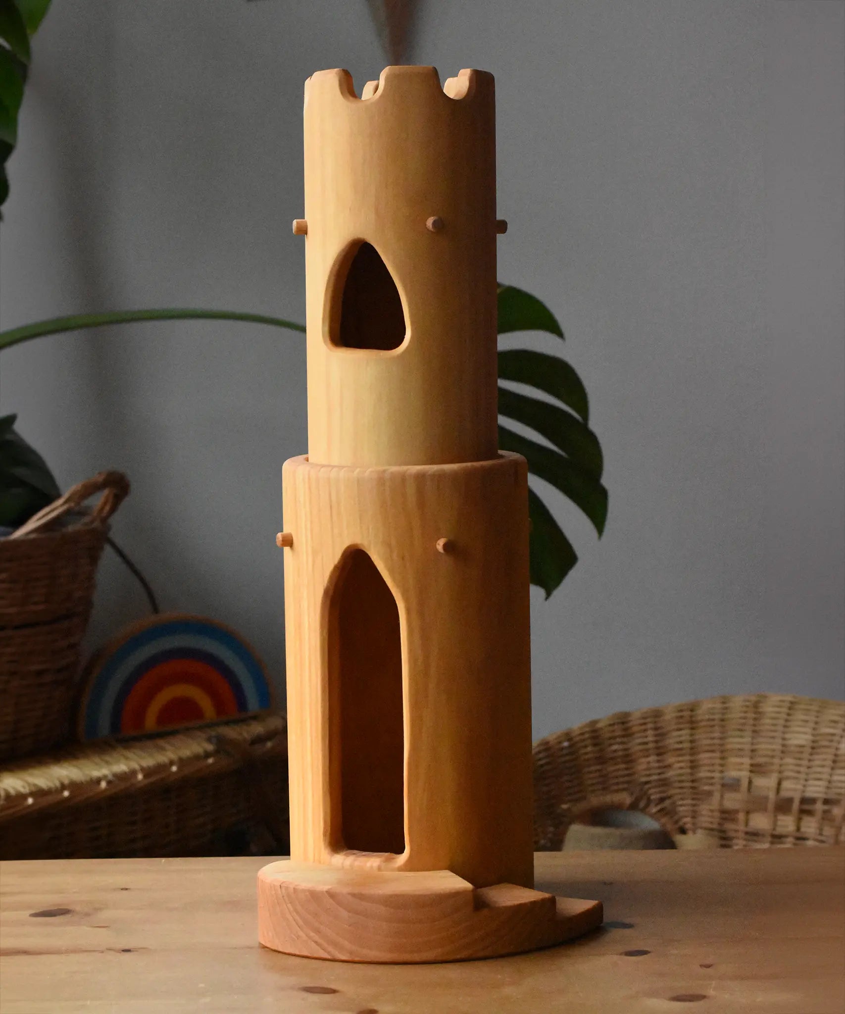 Ostheimer castle round tower with stairs wooden toy building placed on a wooden surface.