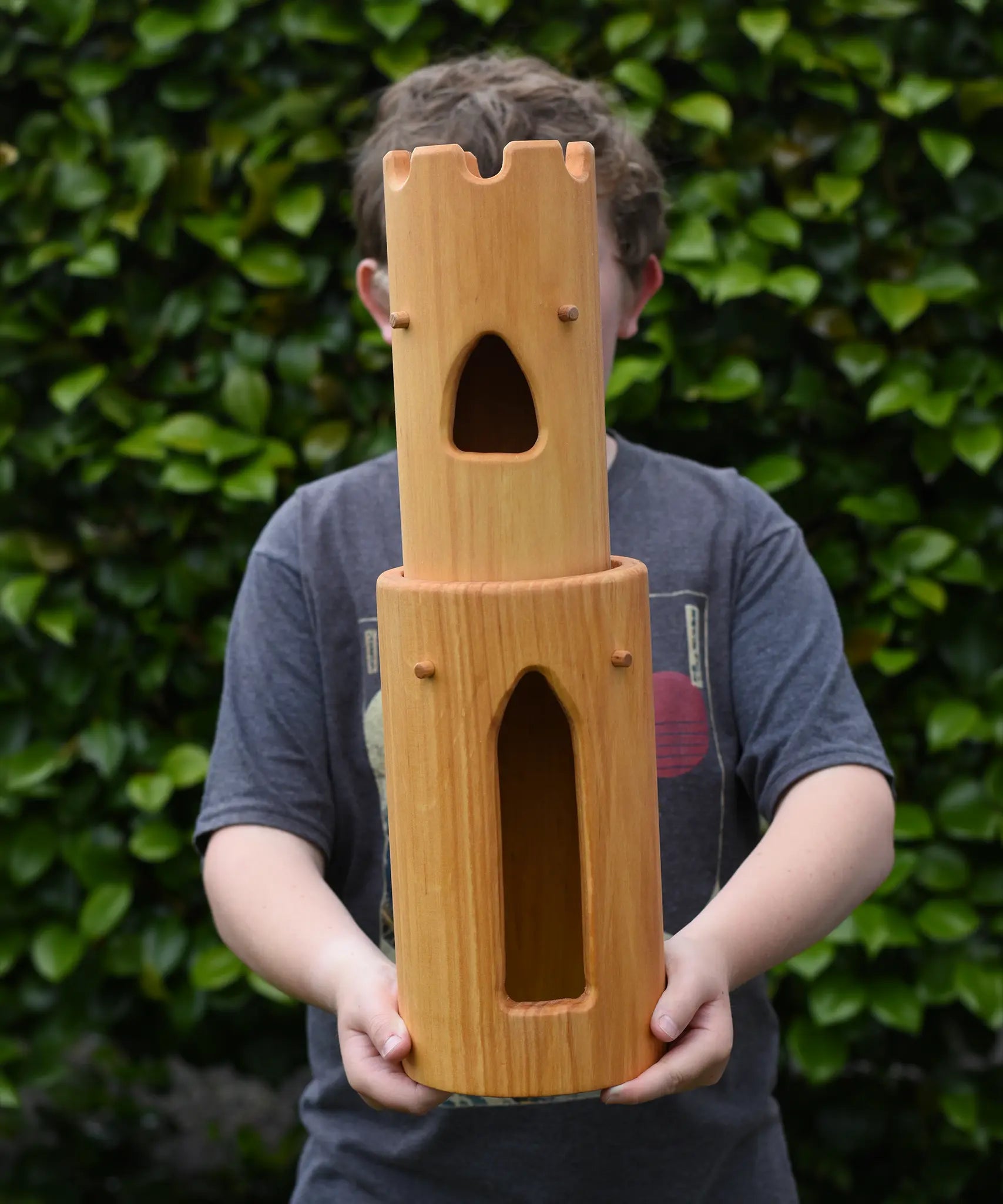 Ostheimer castle round tower with stairs wooden toy building in a child's hands.