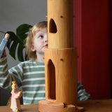 Ostheimer castle round tower with stairs wooden toy building with a child standing behind looking up at the top of the tower.