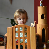 Ostheimer wooden castle trellised gate with castle walls either side and a castle round tower in the background.