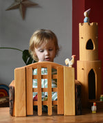 Ostheimer wooden castle trellised gate with castle walls either side and a castle round tower in the background.