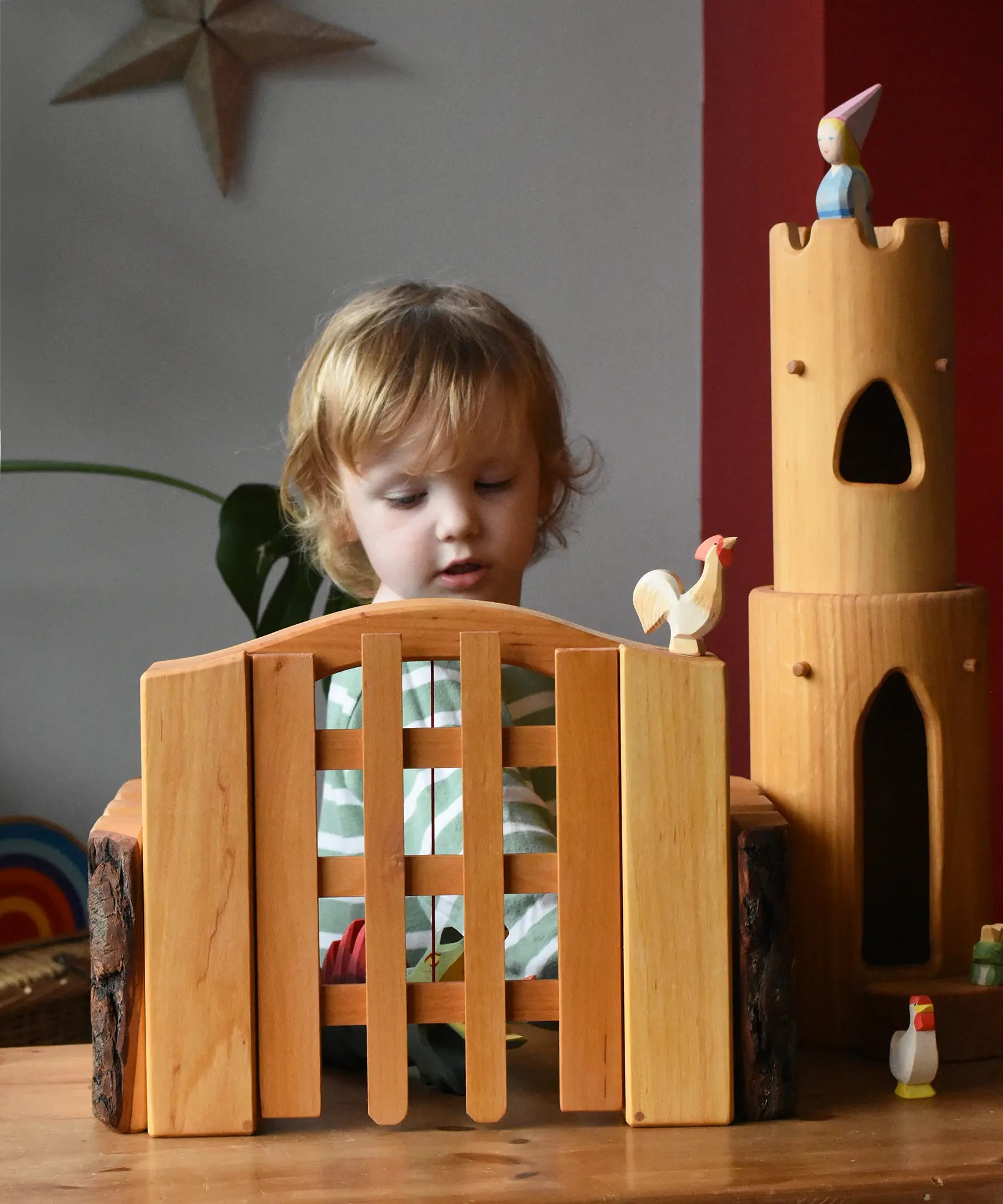 Ostheimer wooden castle trellised gate with castle walls either side and a castle round tower in the background.
