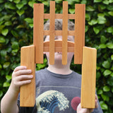 Ostheimer wooden castle trellised gate in a child's hands with the gate open.