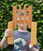 Ostheimer wooden castle trellised gate in a child's hands with the gate open.