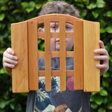 Ostheimer wooden castle trellised gate in a child's hands.