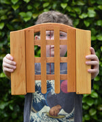 Ostheimer wooden castle trellised gate in a child's hands.
