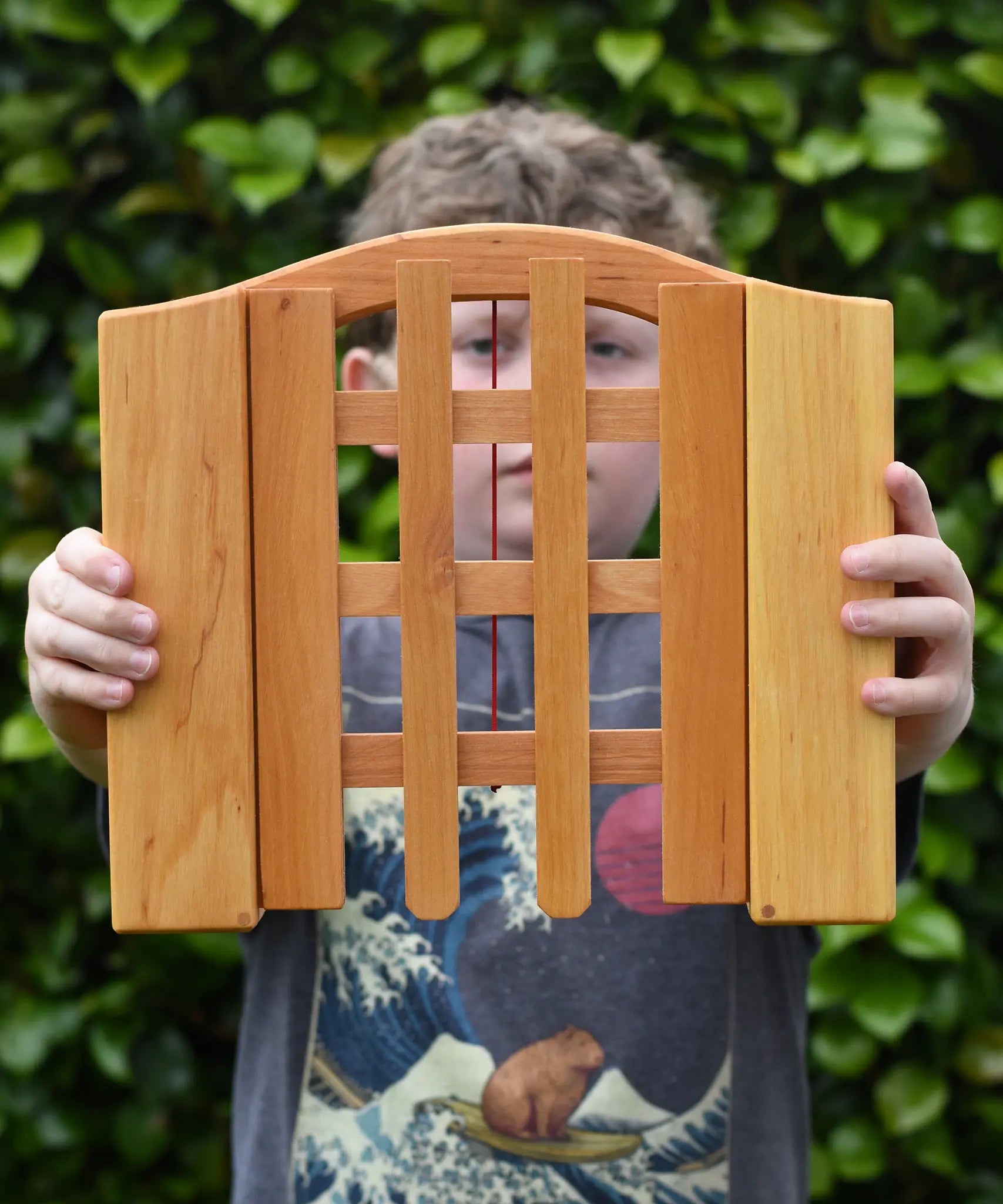 Ostheimer wooden castle trellised gate in a child's hands.