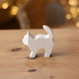 Ostheimer paint your own standing cat figure placed on a wooden surface.