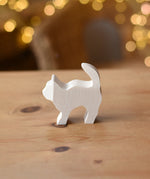 Ostheimer paint your own standing cat figure placed on a wooden surface.