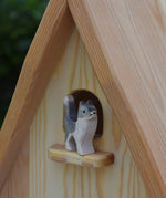An Ostheimer wooden Waldorf style wooden toy figure placed on a perch on the fairy tale dolls house. These wooden figures are part of a large range of expertly hand crafted, Waldorf inspired, wooden toys here at Babipur.