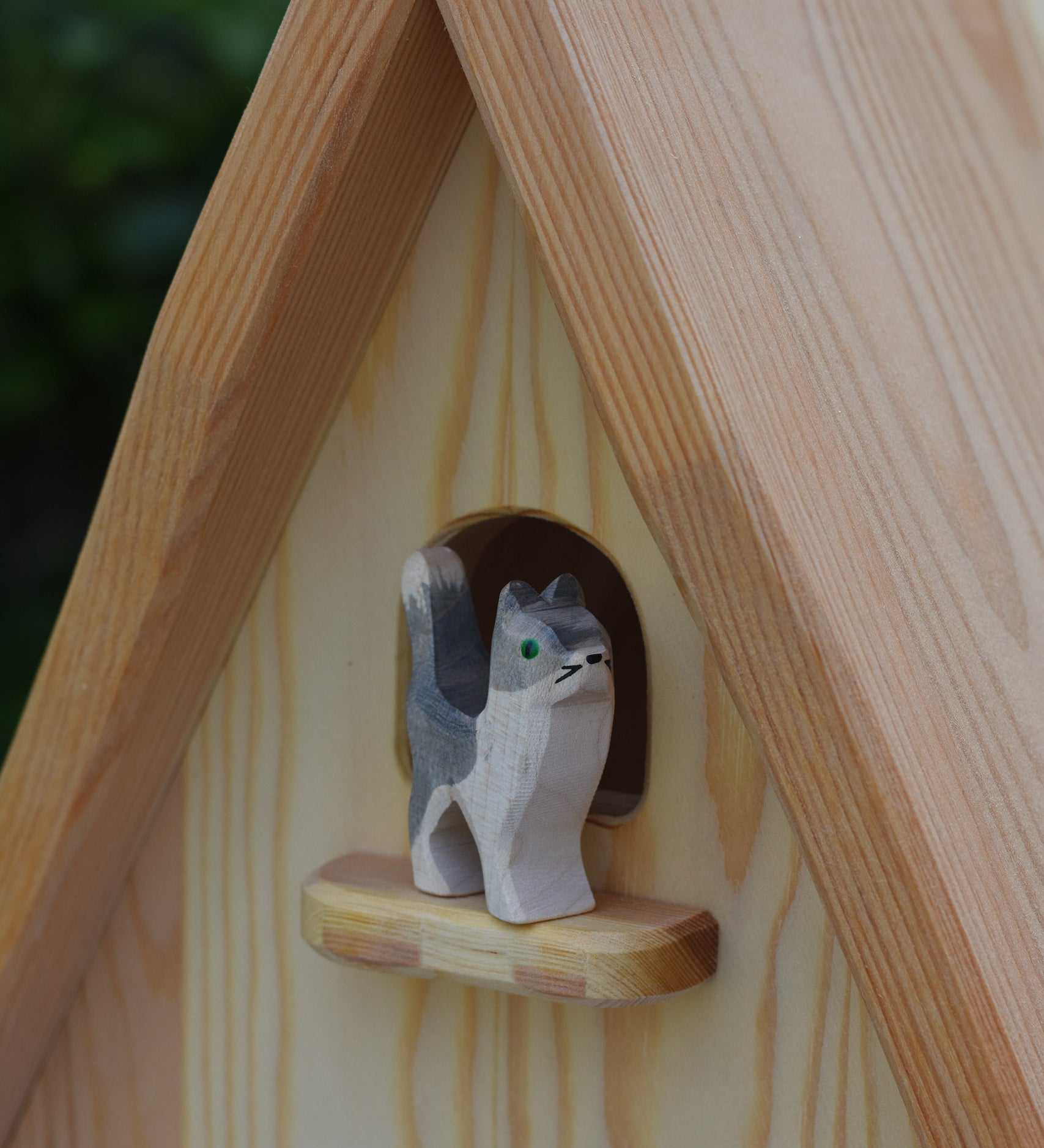An Ostheimer wooden Waldorf style wooden toy figure placed on a perch on the fairy tale dolls house. These wooden figures are part of a large range of expertly hand crafted, Waldorf inspired, wooden toys here at Babipur.