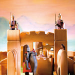 Close up of some wooden knight figures stood on the Ostheimer castle gate and towers set