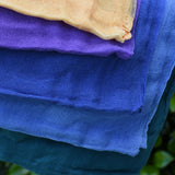 Close up of the Ostheimer Christmas decoration scarves play cloths draped over a child's arm.