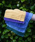 Ostheimer Christmas decoration scarves play cloths draped over a child's arm.