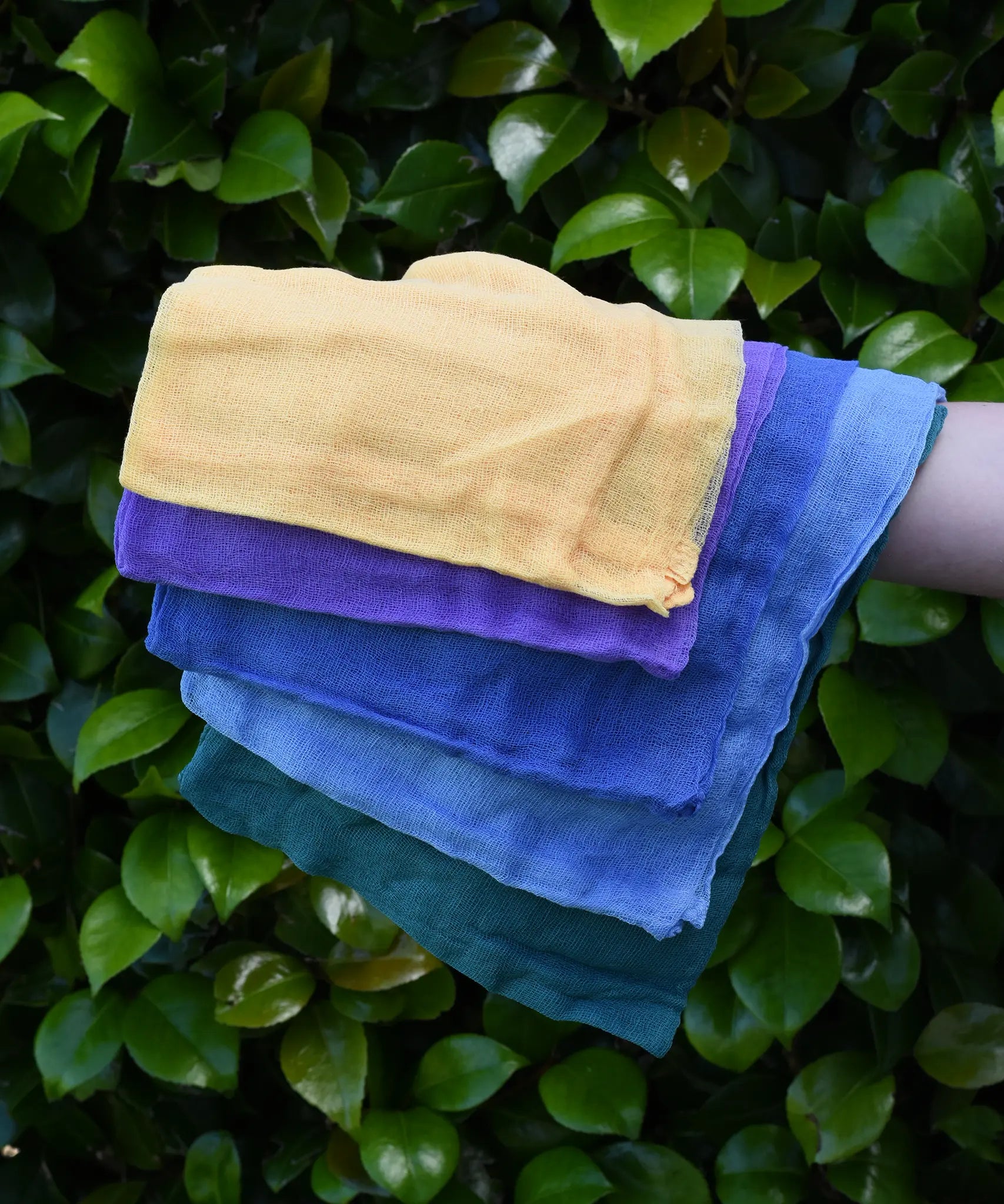 Ostheimer Christmas decoration scarves play cloths draped over a child's arm.