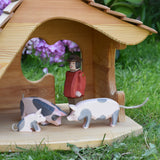 Ostheimer pig figures placed in the Ostheimer wooden cottage with a male farmer figure. These wooden figures are part of a large range of expertly hand crafted, Waldorf inspired, wooden toys here at Babipur. 
