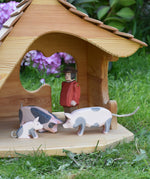 Ostheimer pig figures placed in the Ostheimer wooden cottage with a male farmer figure. These wooden figures are part of a large range of expertly hand crafted, Waldorf inspired, wooden toys here at Babipur. 
