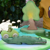 Ostheimer crocodile wooden toy figure placed on a pond piece in a small world play scene. 