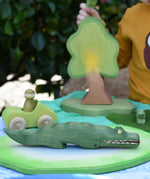 Ostheimer crocodile wooden toy figure placed on a pond piece in a small world play scene. 