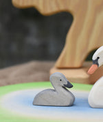 An Ostheimer grey coloured cygnet placed on a pond scene piece. 
