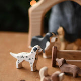 A Ostheimer dalmatian wooden toy dog figure in a small world play scene with other dogs. These wooden figures are part of a wide range of expertly hand crafted wooden toys here at Babipur. 
