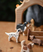 A Ostheimer dalmatian wooden toy dog figure in a small world play scene with other dogs. These wooden figures are part of a wide range of expertly hand crafted wooden toys here at Babipur. 