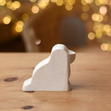 Ostheimer dog paint your own wooden figure placed on a wooden surface. 