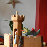 Ostheimer castle tower with castle walls with a dragon figure, medieval princess and frog king and princess set up in a simple small world play scene. 