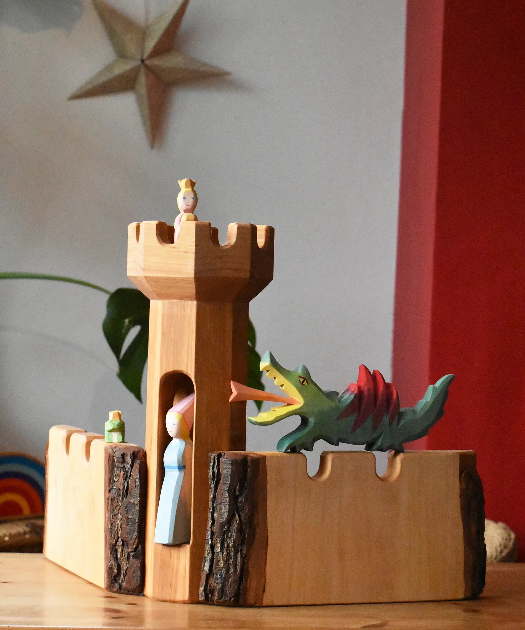 Ostheimer castle tower with castle walls with a dragon figure, medieval princess and frog king and princess set up in a simple small world play scene. 